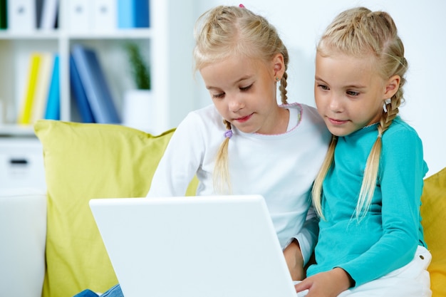 Sisters using laptop