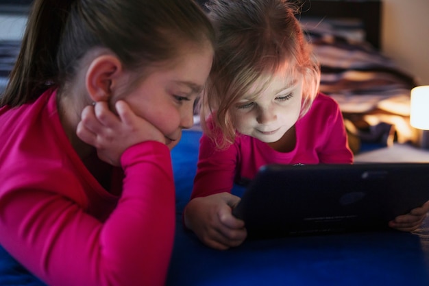 Sisters watching video on table