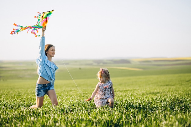 Sisters with kite in field