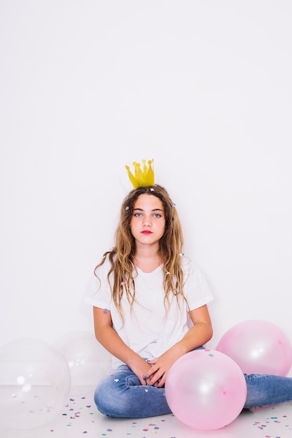 Sit girl surrounded by balloons