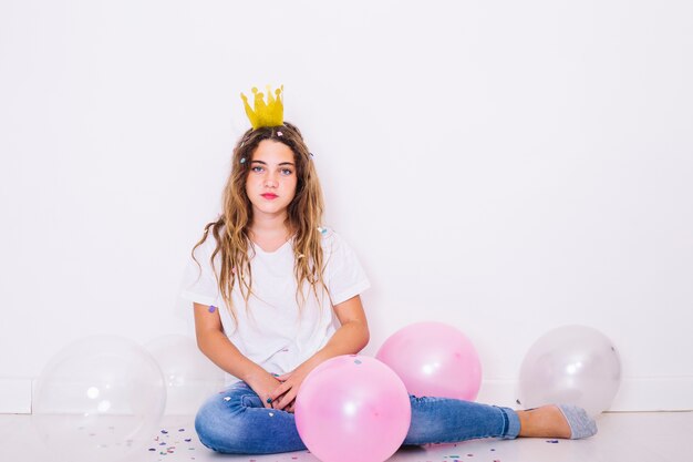 Sit girl surrounded by balloons