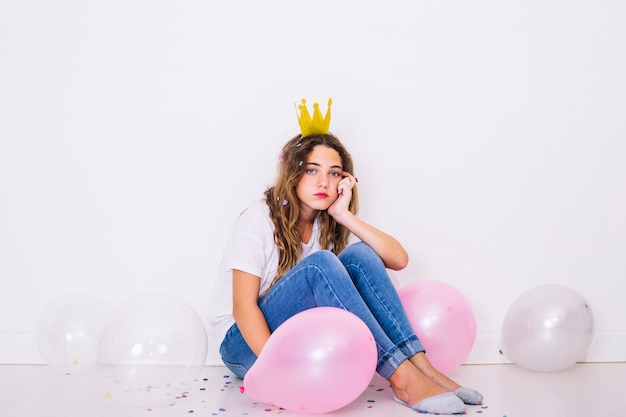 Sit girl surrounded by balloons