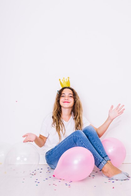 Sit girl surrounded by balloons