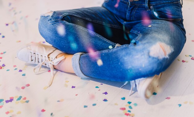 Sitting on the floor surrounded by confetti