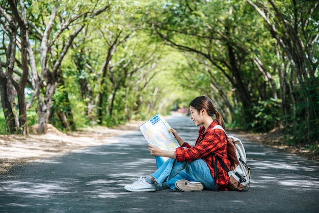 Sitting and watching the map on the road.