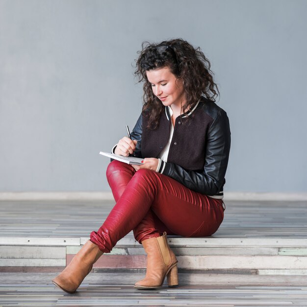 Sitting woman writing