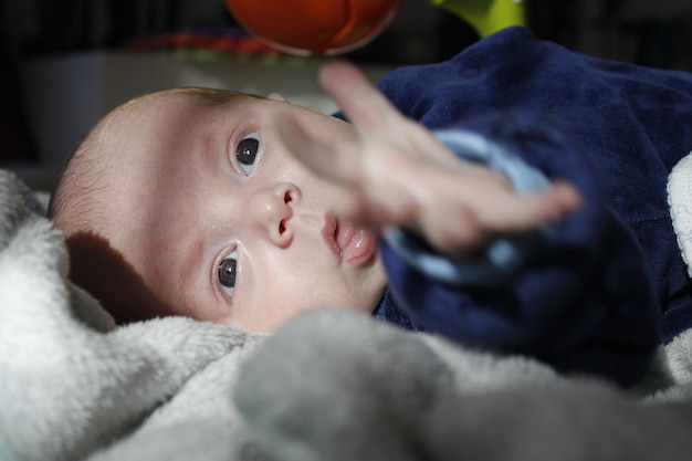 Six-month-old premature baby looks at the front