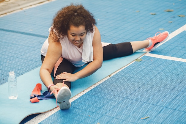 Free photo over the size of a woman doing stretching exercises