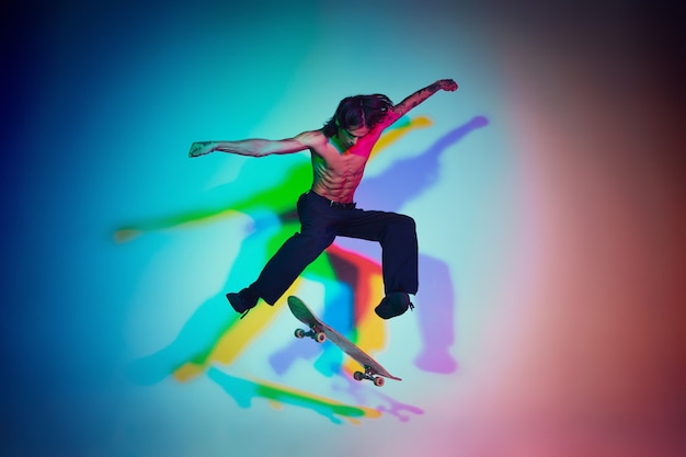 Skateboarder doing a trick isolated on studio