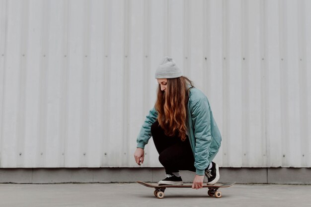 Skateboarder girl riding her skate in the city