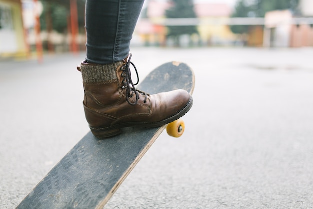 Skateboarder legs riding skateboard