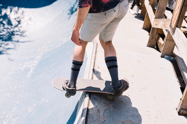 Skater balancing on edge of ramp