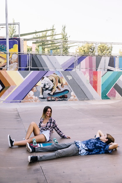 Skater couple chilling in urban environment