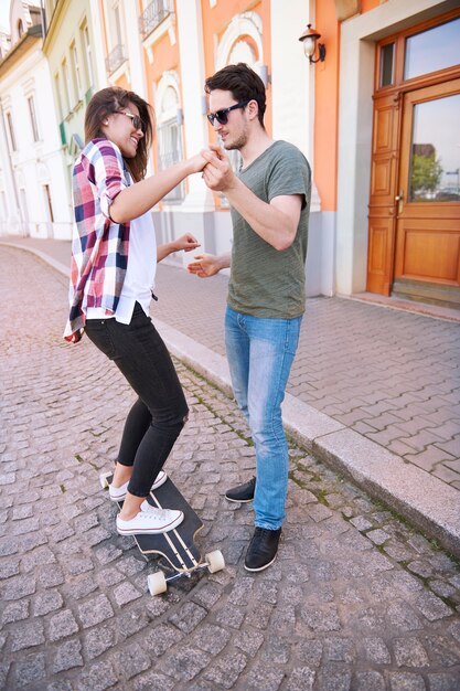 Skater couple practicing in the street