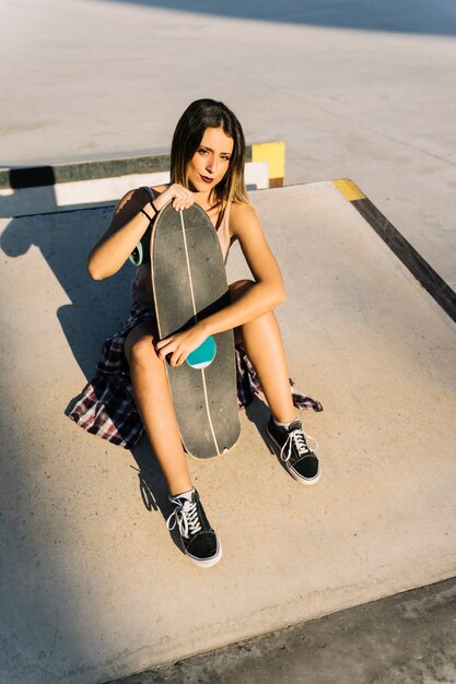 Skater girl holding board