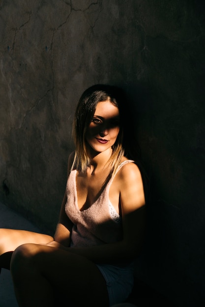 Skater girl sitting in shadows