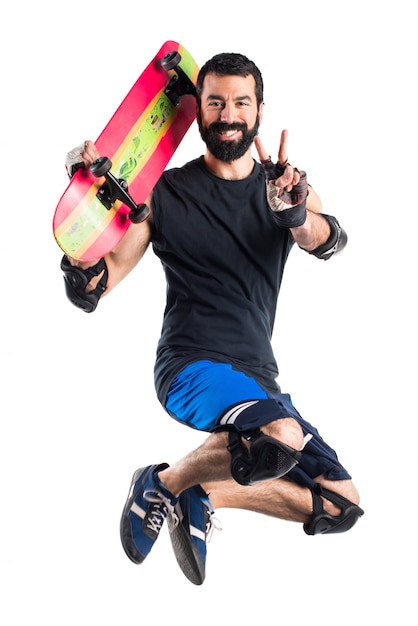 Skater jumping doing victory gesture