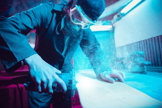 Skater in process of making his own skateboard