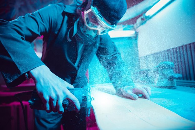 Skater in process of making his own skateboard