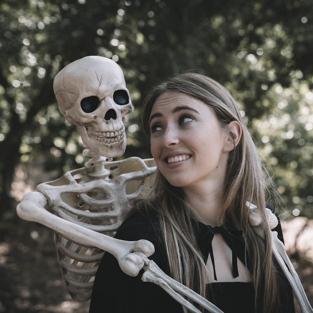 Skeleton hugging behind lady 