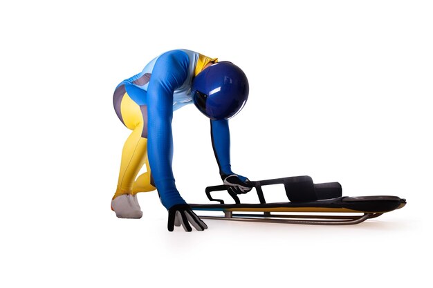 Скелетонный спорт Бобслей Санный спорт Спортсмен спускается на санях на белом фоне