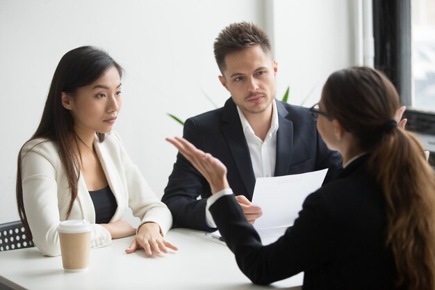 Skeptical diverse hr managers interviewing female applicant, bad first impression