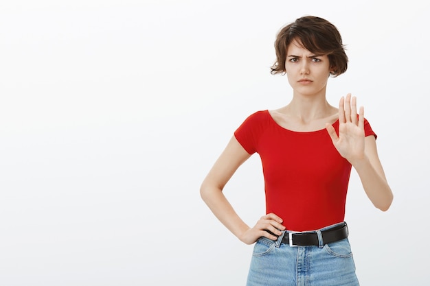 Skeptical and reluctant woman raising hands in rejection, refuse offer, telling to stop