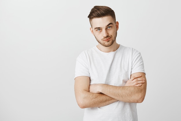 Skeptical and unimpressed young guy, cross arms chest and smirk displeased