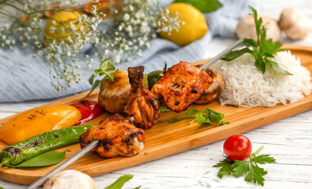 Skewered chicken kebab with rice and vegetables