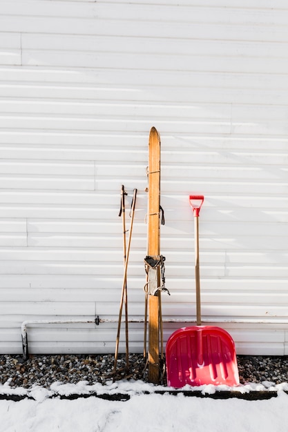 Бесплатное фото Лыжи и лопата у стены