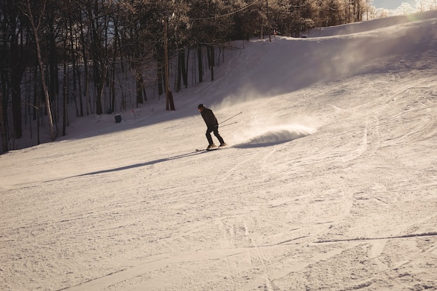 Free photo skier skiing on the mountain slope