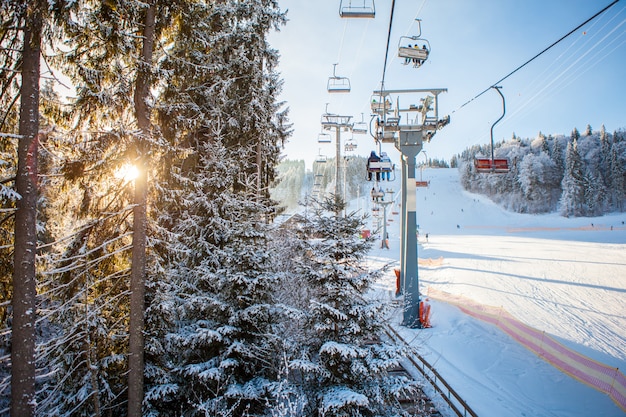 Free photo skiers on the ski lift riding up at ski resort