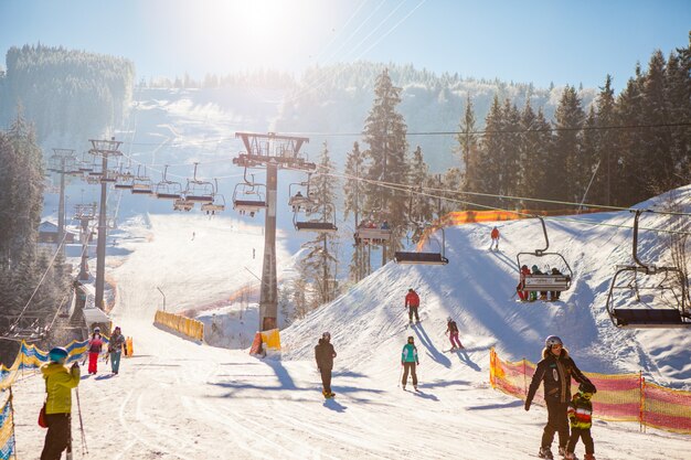 Лыжники на подъемнике едут на горнолыжном курорте