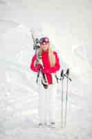 Free photo skiing in mountains. bright color of ski clothes. girl spends time skiing.