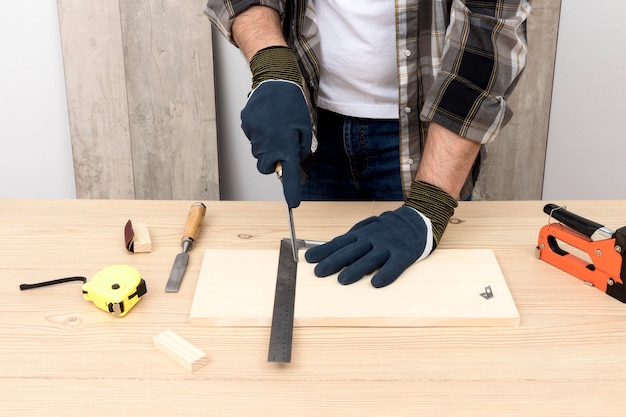 Skilled carpenter using protection gloves