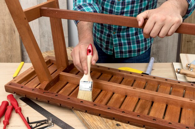 Skilled carpenter worker using his tools on wood