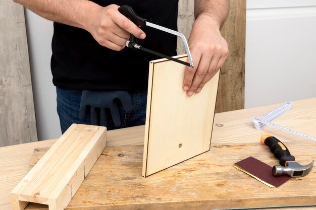 Skilled carpenter worker using his tools on wood