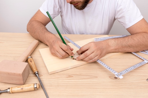 Skilled carpenter worker using his tools on wood