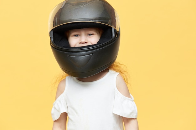 Skillful experienced little girl in safety motorcycle helmet