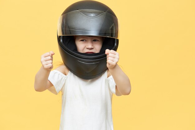 Skillful experienced little girl in safety motorcycle helmet