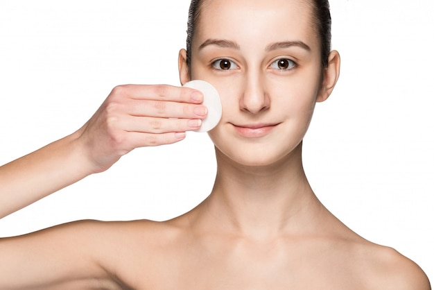 Skin care woman removing face with cotton swab pad