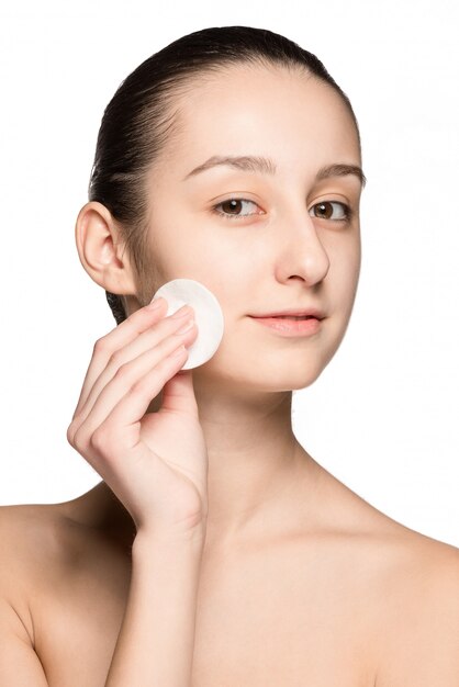 Skin care woman removing face with cotton swab pad