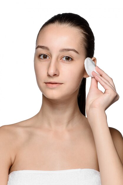 Skin care woman removing face with cotton swab pad