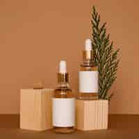 Free photo skin oil droppers assortment with wooden pieces