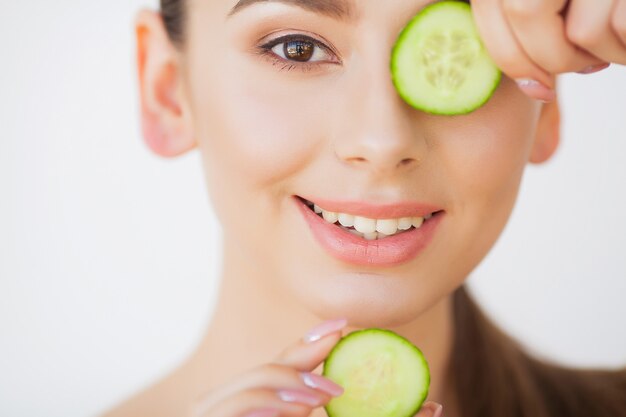 Skincare. beautiful young woman with cucumbers on eyes
