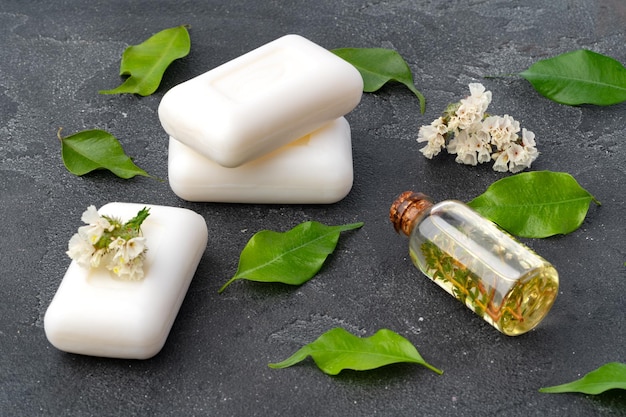 Skincare organic soap bars with plants extracts on gray surface