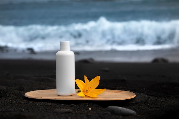 Skincare tube product on black canarian sand.