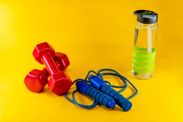 Skipping rope, dumbbells, and bottle of water