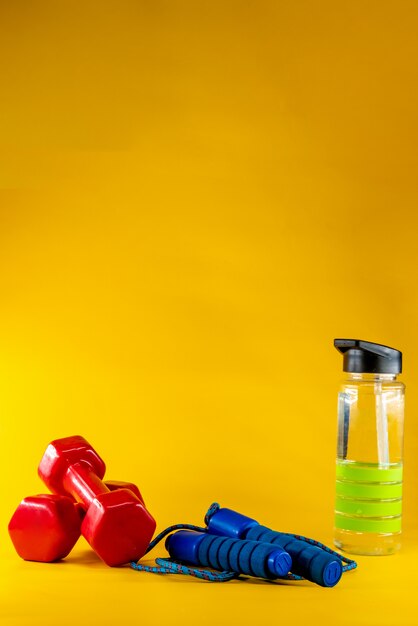 Skipping rope, dumbbells, and bottle of water