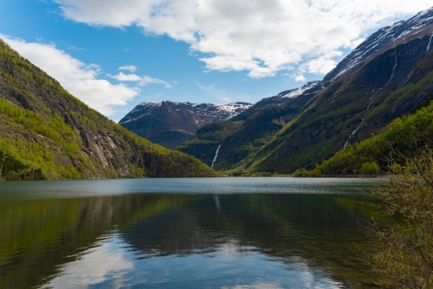Free photo skjolden norway may 16 2023 mountain and waterfall